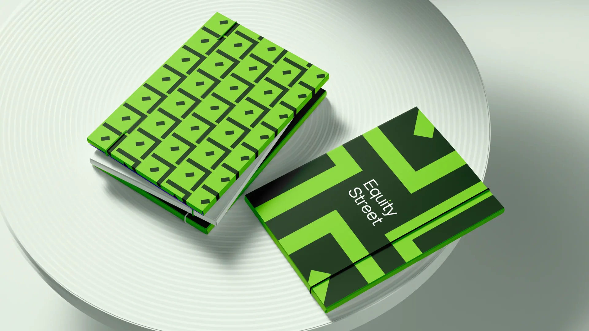 Equity Street brand identity applied to geometric green notebooks